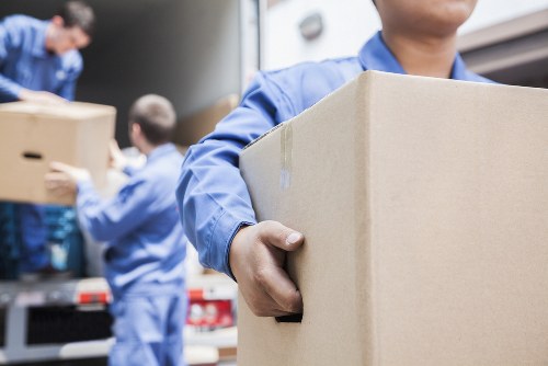 Professional man and van service moving boxes in Camden