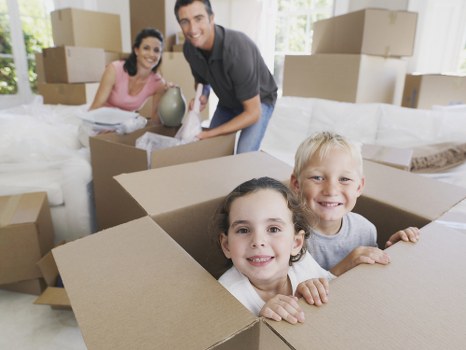 Removal company workers loading furniture into a moving van