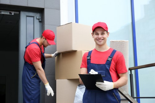 Professional team handling piano removals in Camden with protective wrapping