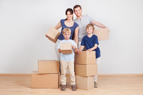 Professional movers carrying furniture during a house move in Camden