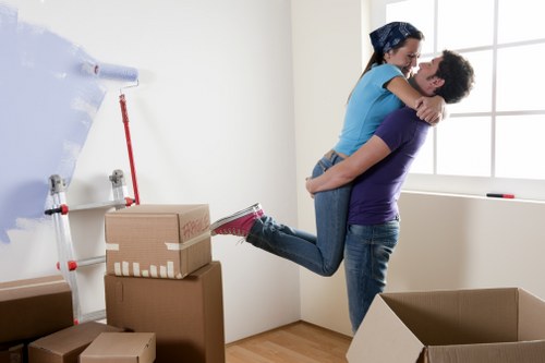 Camden furniture removals team handling household items in a narrow street