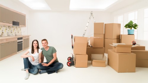 Team handling a furniture move with protective coverings
